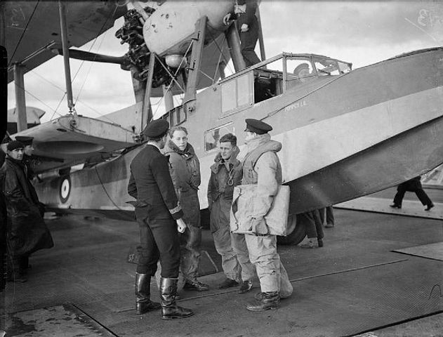 Pilot, observer and air gunner reporting to their Commanding Officer from HMS ARGUS