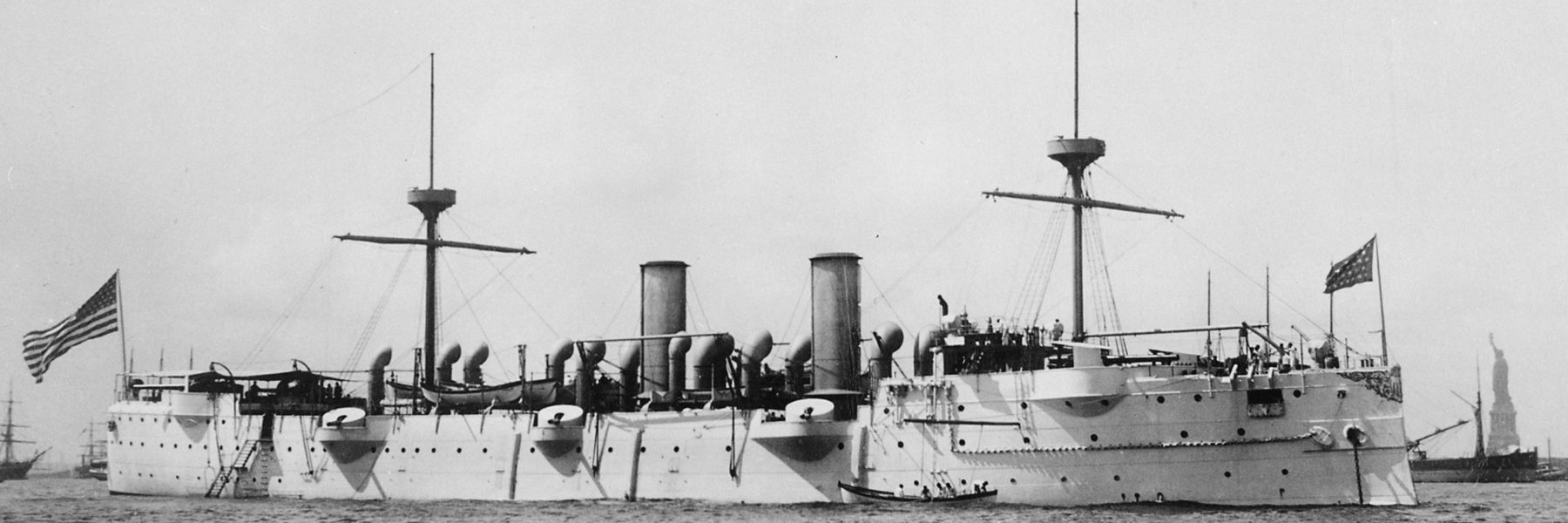 USS baltimore in New York - Statue of Liberty can be seen to the right in the foreground.