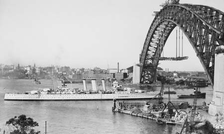 HMAS Camberra under the Sydney bridge in 1930