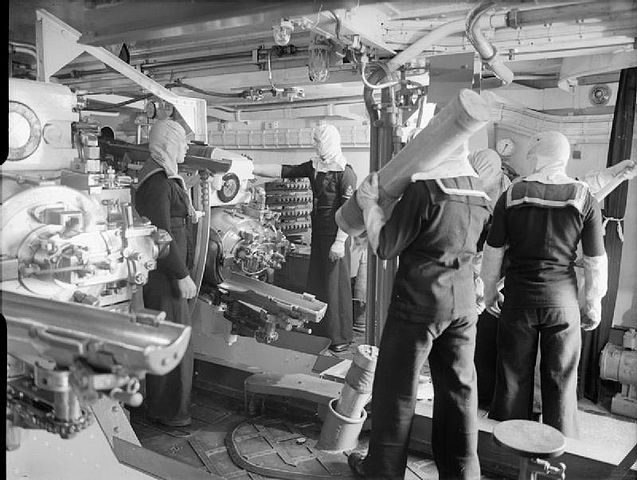 Gunner and loaders inside HMS Jamaica's turret