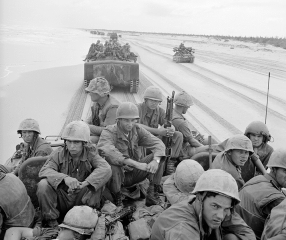 LVTP-5's of the USMC's carrying 3rd Marine Division troops along the beach in 1966. Notice the escorting M50 Ontos behind.
